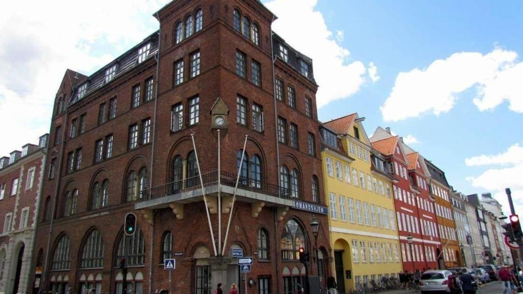 The red-brick corner building of Hotel Bethel at the end of Nyhavn, next to the colourful harbour houses